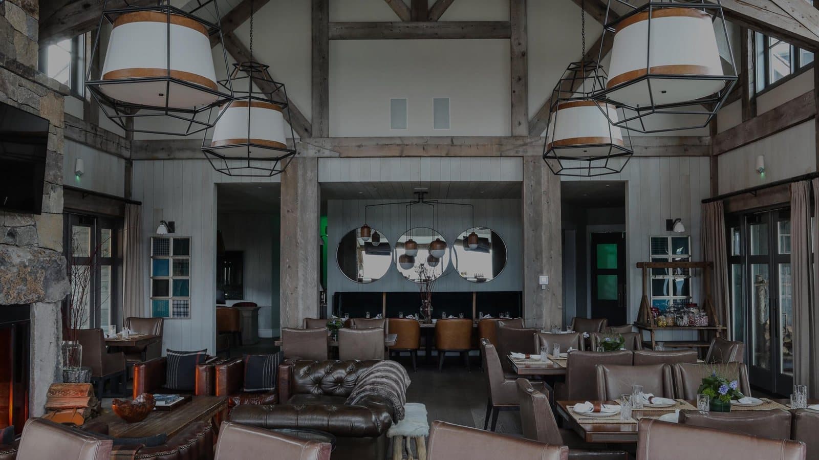 Reclaimed timber-frame beams spanning a vaulted great room interior