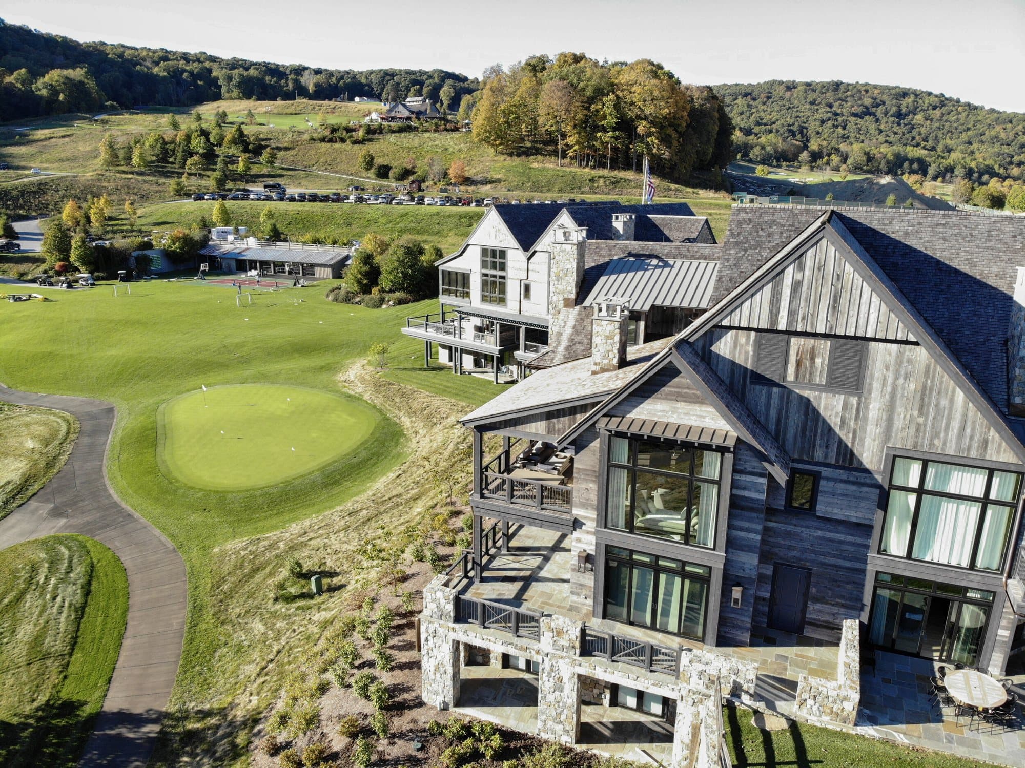 Aerial view of a reclaimed-wood clad estate and clubhouse