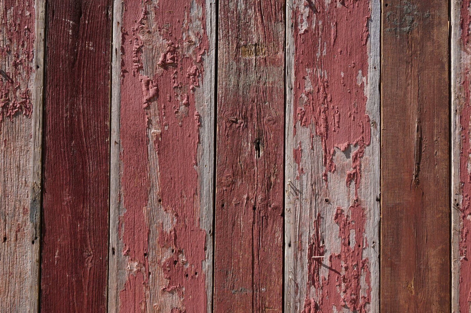 Authentic weathered red barn-board siding with original paint